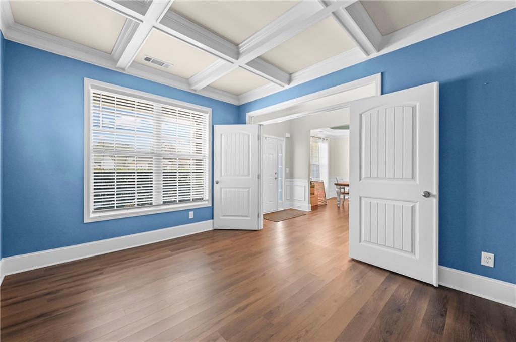 780 Springs Crest Drive Dallas, GA 30157 - Photo 6 of 47 a view of an empty room with wooden floor and a window