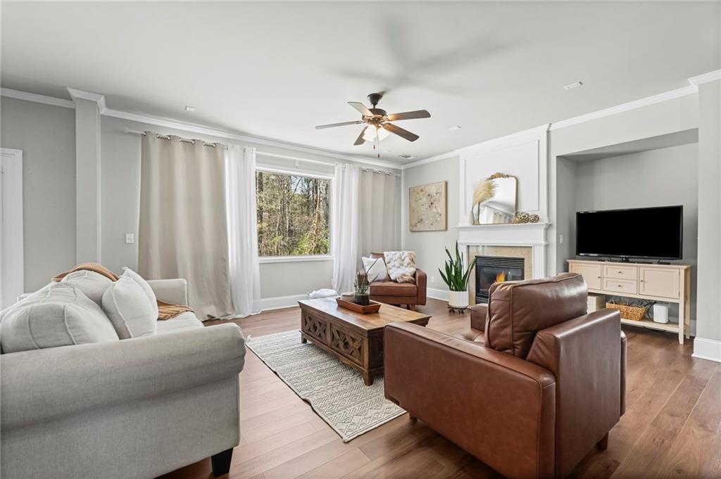 780 Springs Crest Drive Dallas, GA 30157 - Photo 8 of 47 a living room with furniture a flat screen tv and a fireplace