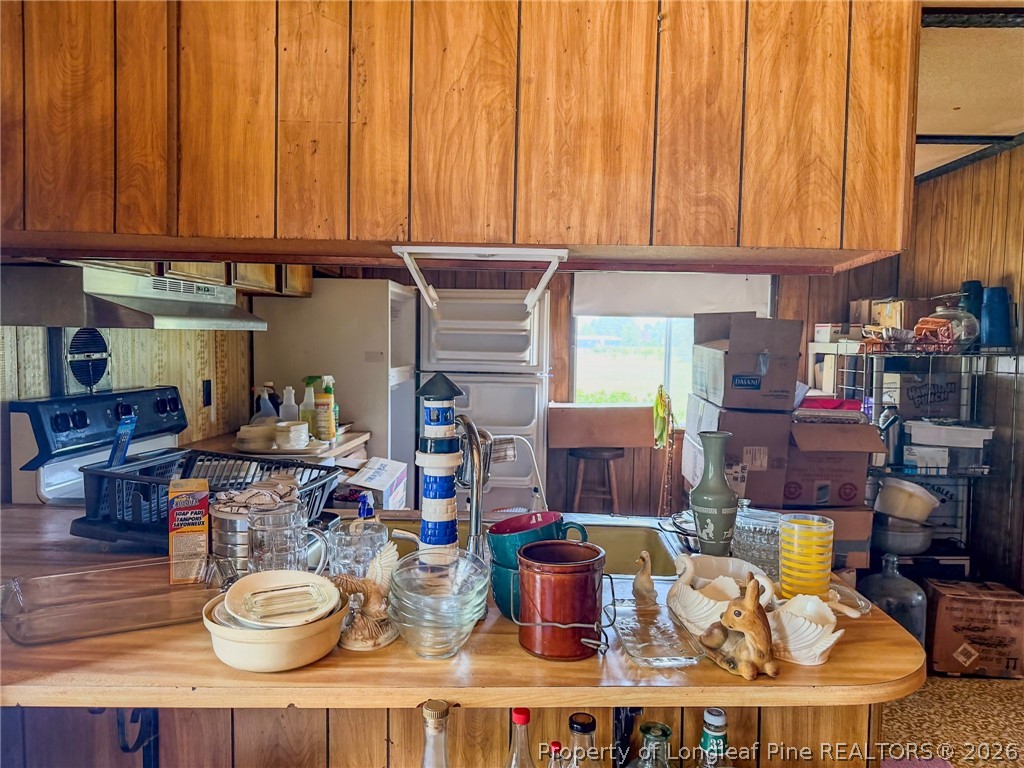 1308 Mac D Road Orrum, NC 28369 - Photo 20 of 32 a kitchen with a stove a sink and a cabinets