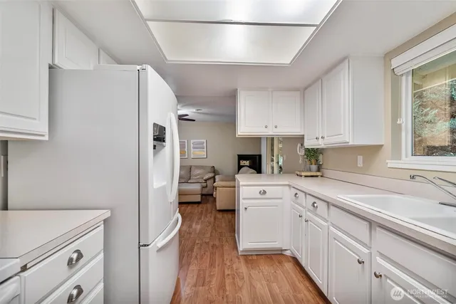 a kitchen with white cabinets and white appliances