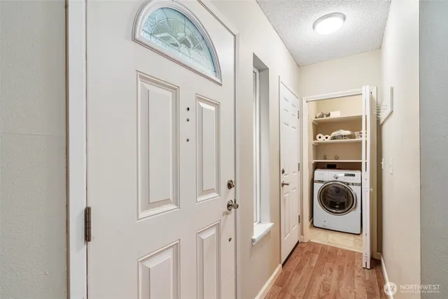 a view of a hallway with washer and dryer