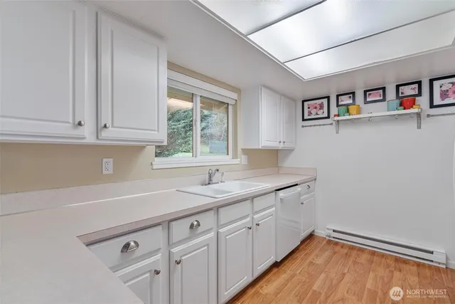 a kitchen with a sink cabinets and window