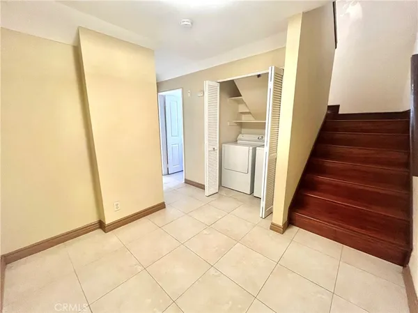 a view of entryway with wooden floor and cabinet