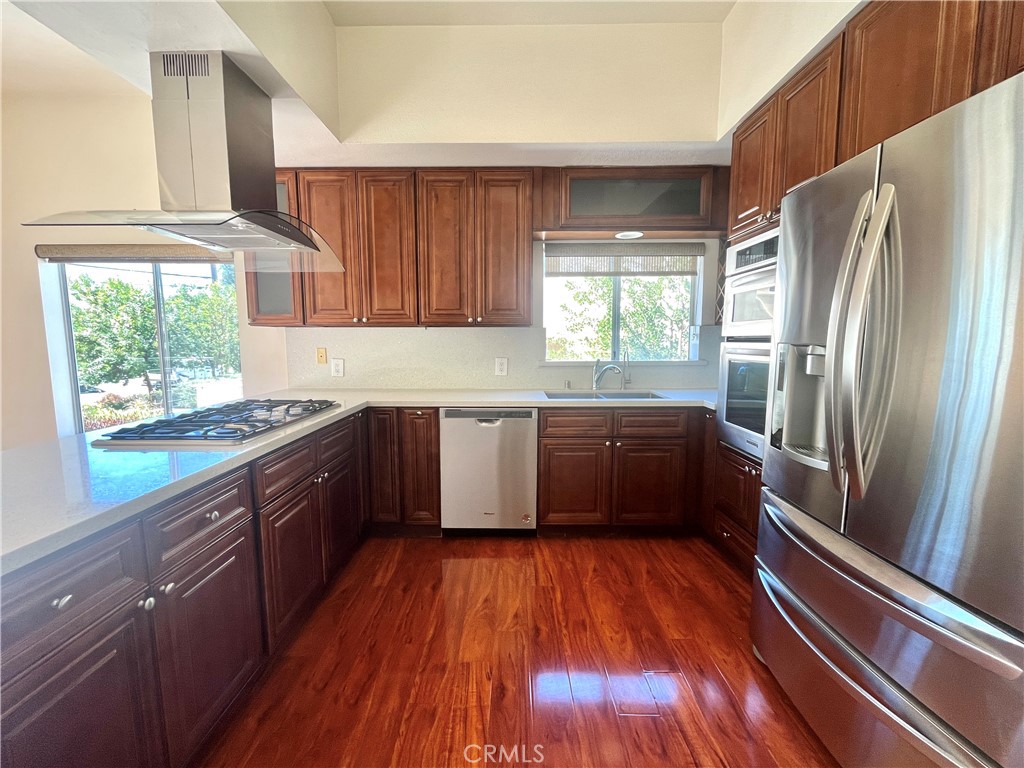 609 Fairview Avenue, Unit 2 Arcadia, CA 91007 - Photo 3 of 20 a kitchen with stainless steel appliances wooden floors and wooden cabinets