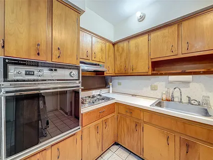 a kitchen that has a sink and a stove