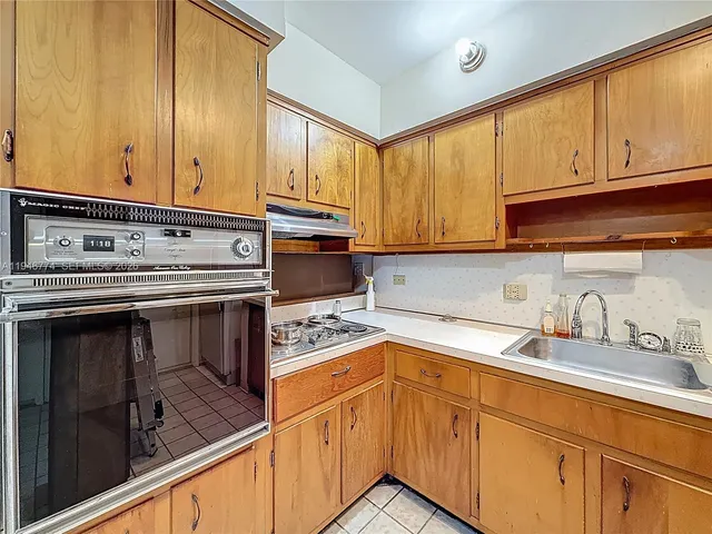 a kitchen that has a sink and a stove