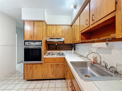 a living room with furniture a flat screen tv and a table