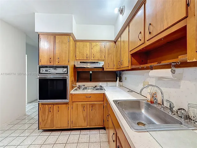 a living room with furniture a flat screen tv and a table