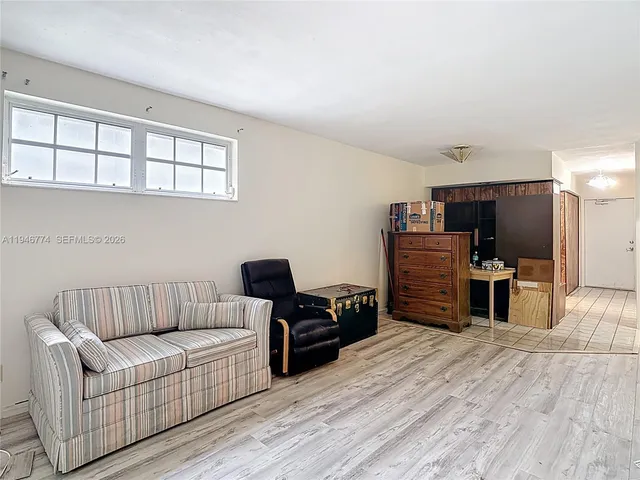 a view of a living room with furniture and wooden floor