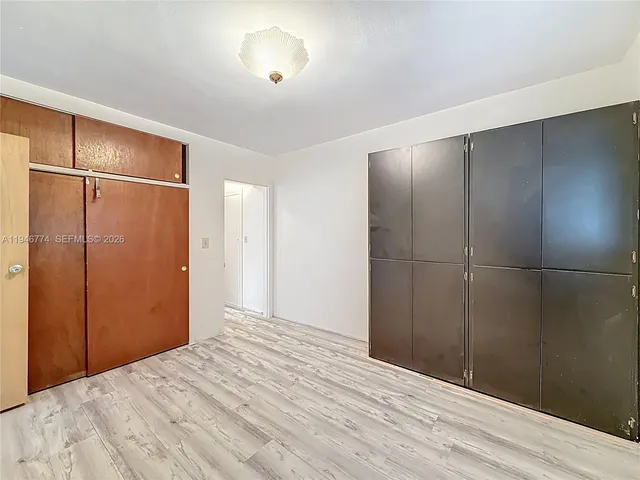 a bathroom with a sink and mirror with bathtub