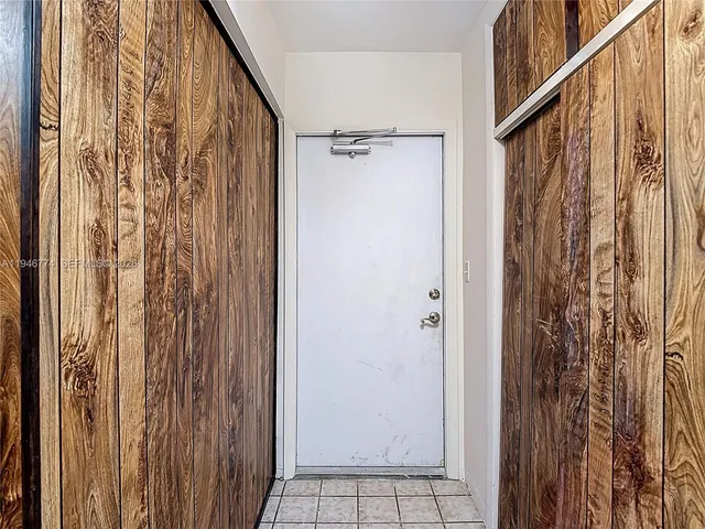 a kitchen with white cabinets and sink