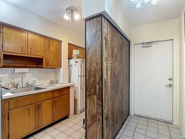 a kitchen with stainless steel appliances granite countertop a sink a stove and cabinets