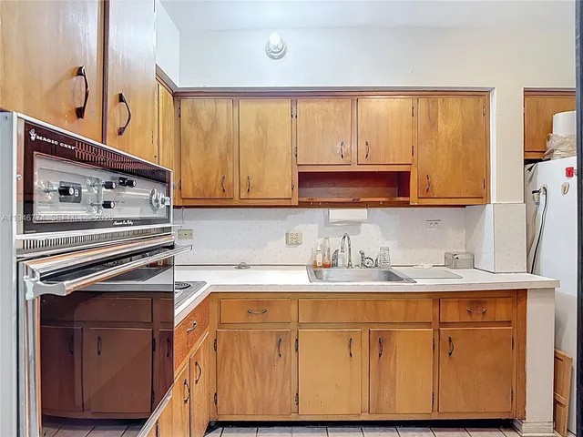 a kitchen with a sink and a refrigerator