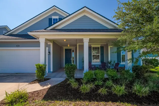 a front view of a house with garden