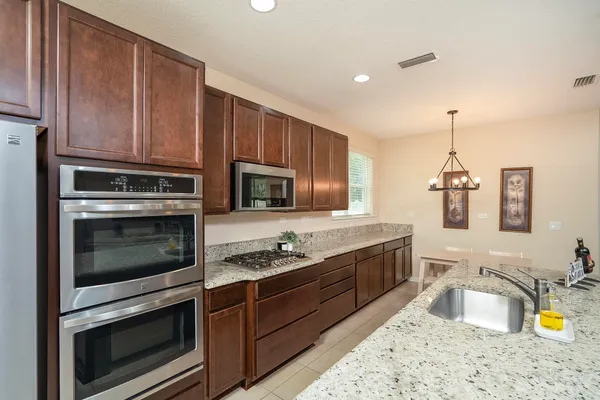 a kitchen with a stove a sink and a microwave