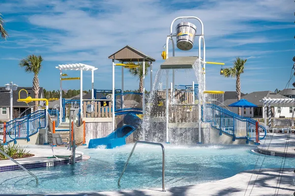 a front view of a house with a fountain