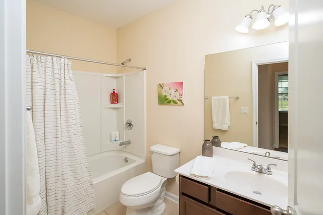 a bedroom with a bed chair and a window