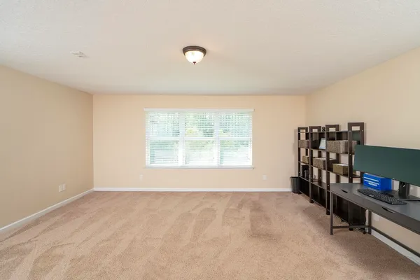 a front view of a multi story residential apartment building with a yard