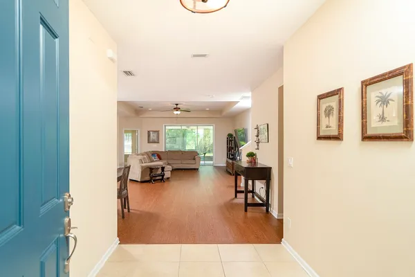 a living room with lots of furniture and kitchen view