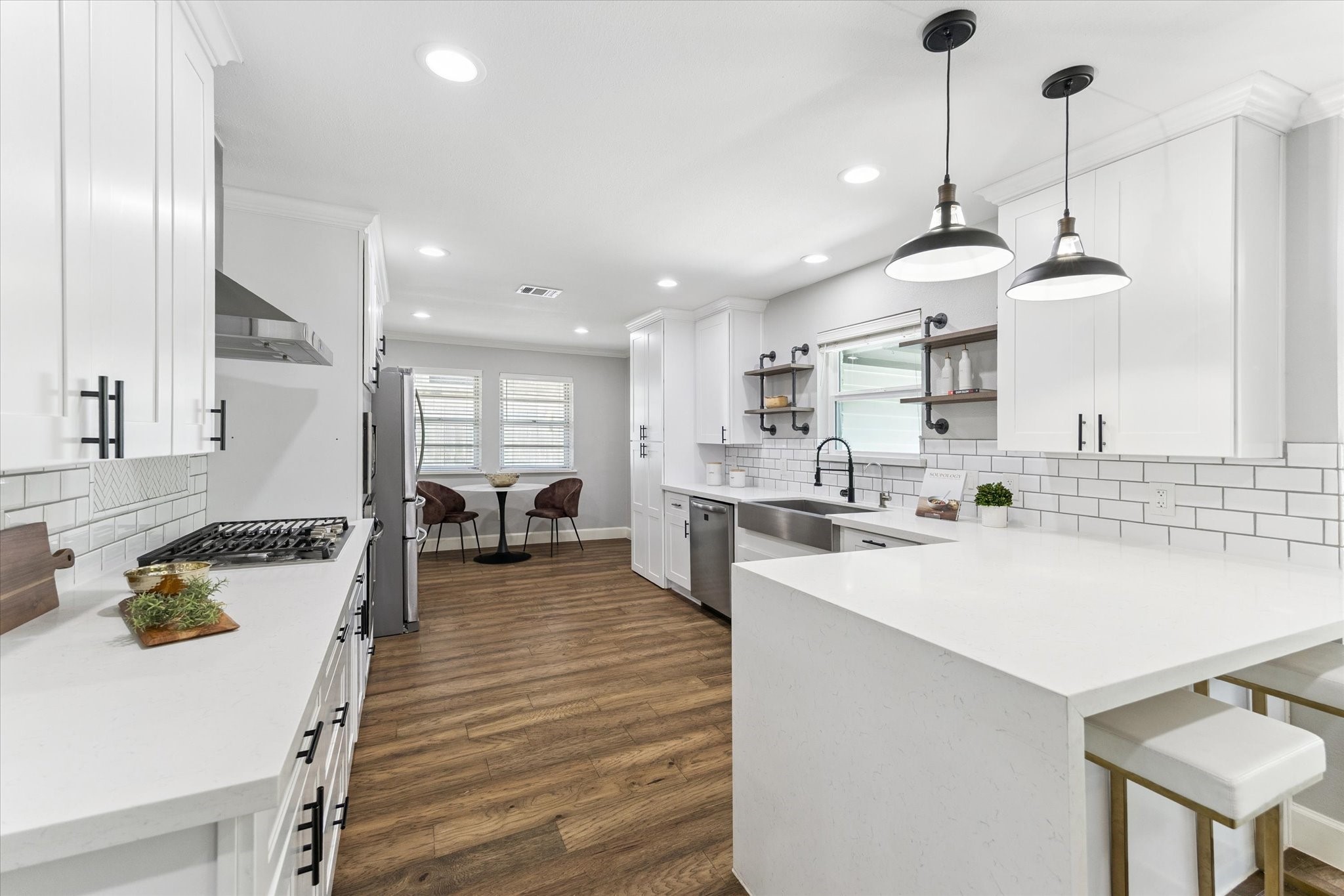 5414 Sanford Road Houston, TX 77096 - Photo 14 of 32 Elevate every culinary endeavor in this work-of-art kitchen where custom soft-close, full-feature cabinetry is trimmed with quartz countertops, subway tile backsplashes and handsome hardware.