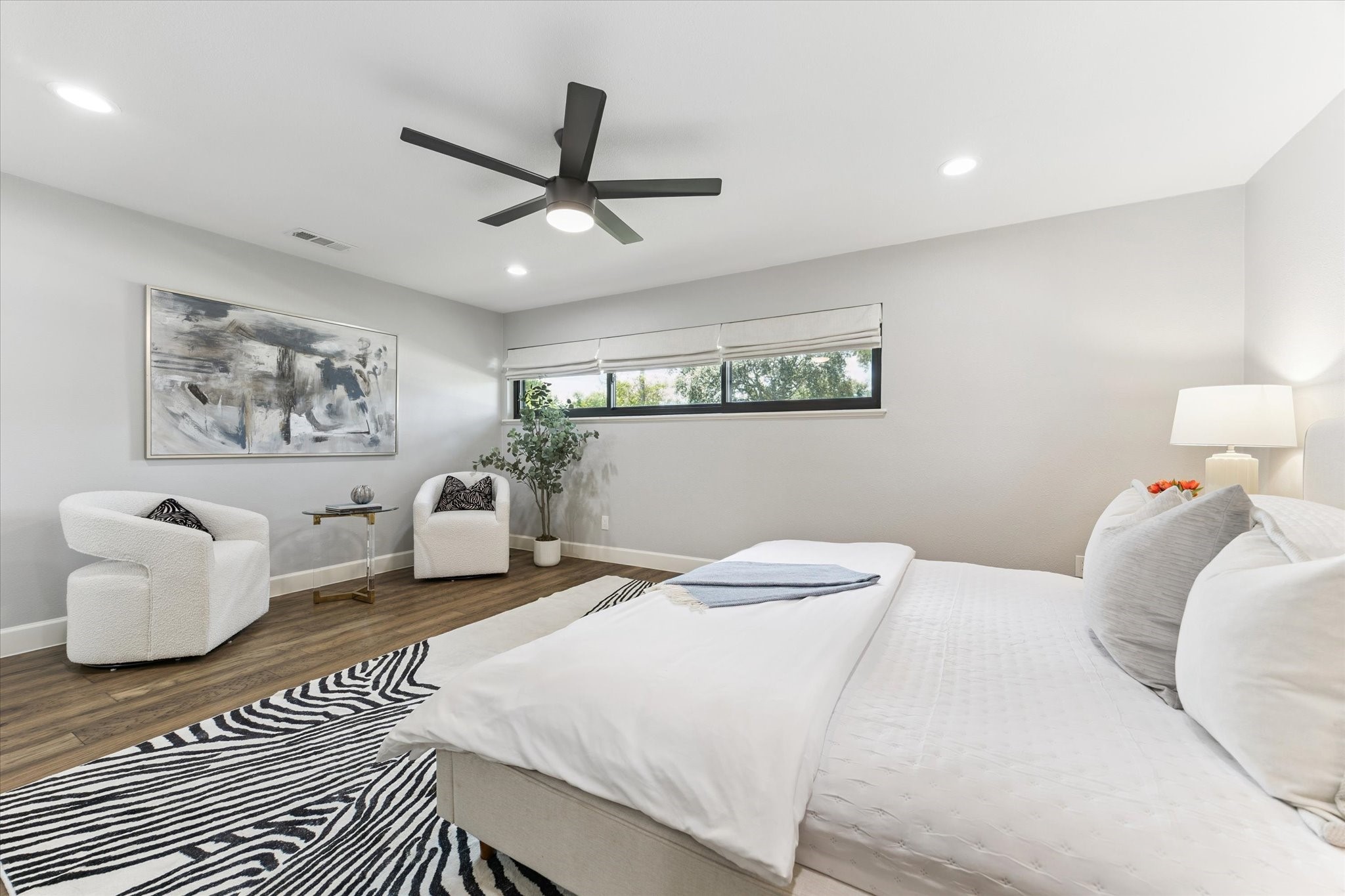 5414 Sanford Road Houston, TX 77096 - Photo 18 of 32 Sleep soundly in the primary bedroom suite featuring a large ceiling fan and wide windows with custom Roman blinds on two exposures.