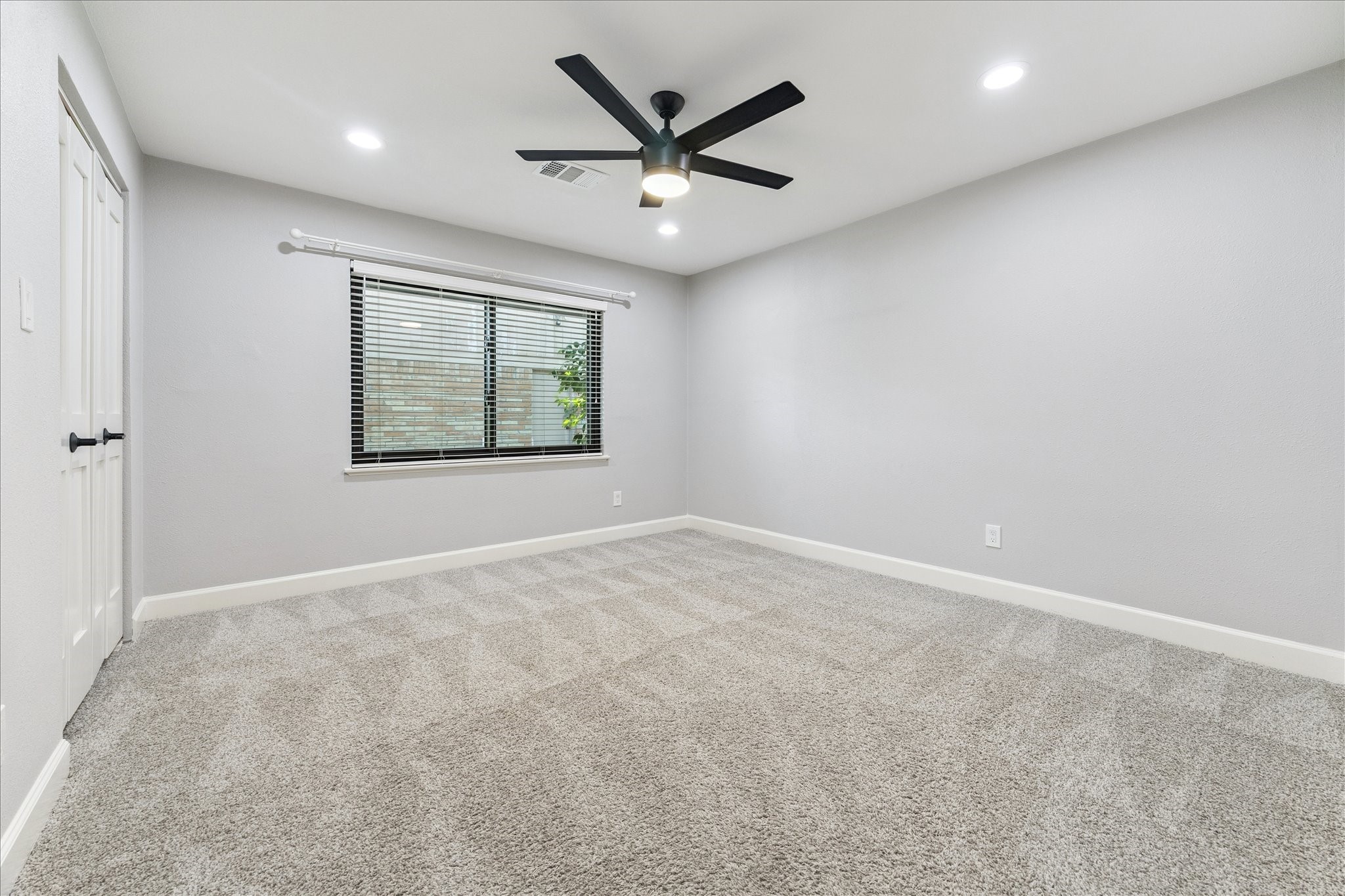 5414 Sanford Road Houston, TX 77096 - Photo 24 of 32 This carpeted third bedroom boasts a ceiling fan, recessed lighting, a large window and a roomy closet.