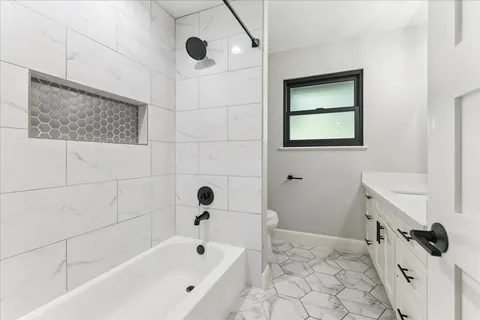 a bathroom with a bathtub and shower