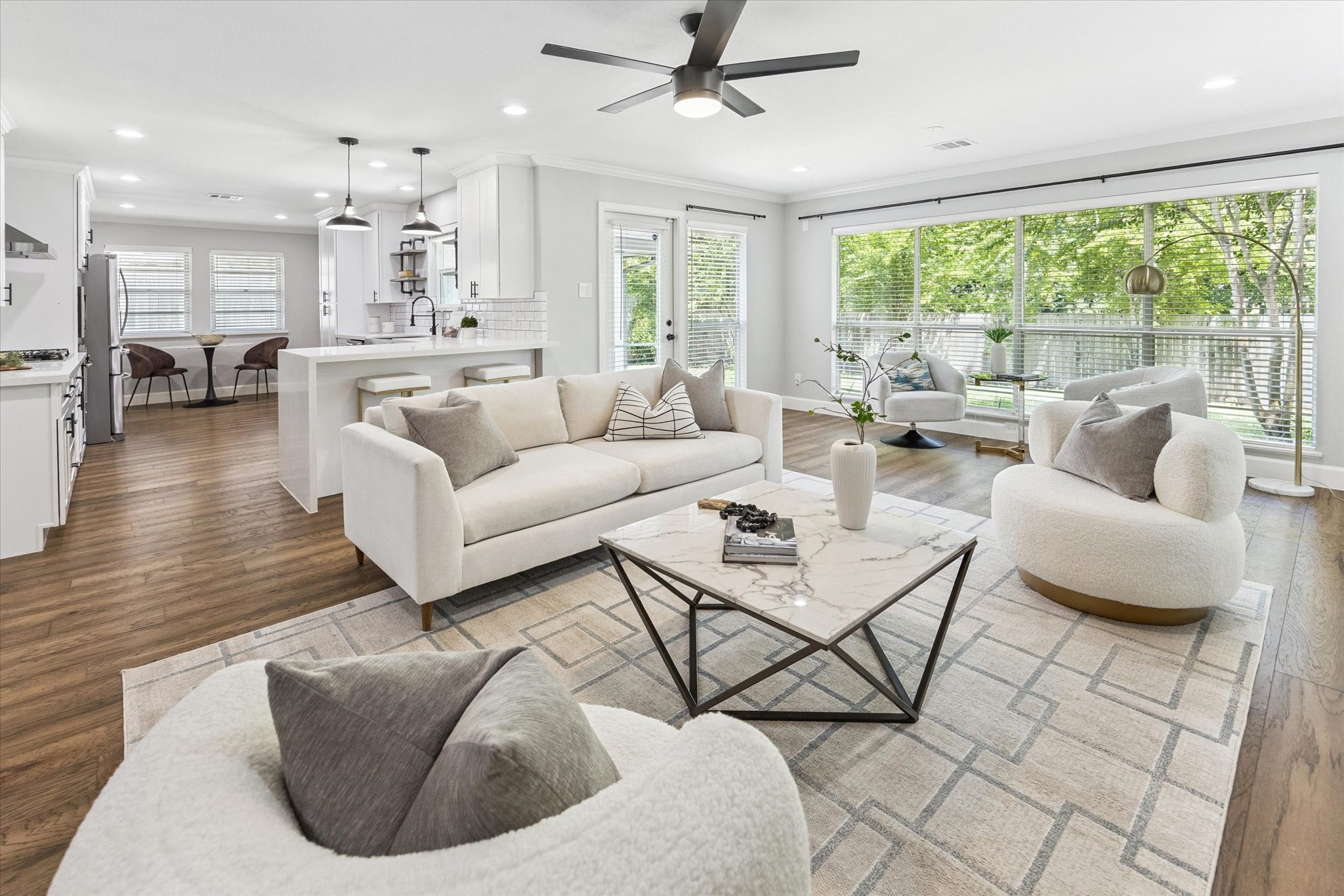 5414 Sanford Road Houston, TX 77096 - Photo 10 of 32 Leafy outdoor views surround this inviting living room while a contemporary ceiling fan ensures year-round comfort.