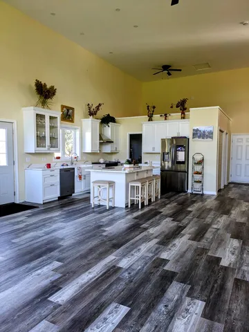 a view of a big yard with a house in the background