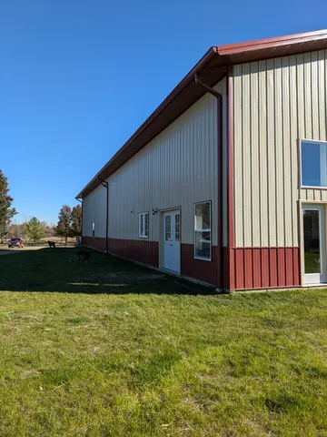a living room with stainless steel appliances kitchen island granite countertop a stove and a refrigerator