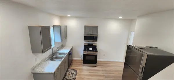 a room with a bed and a television