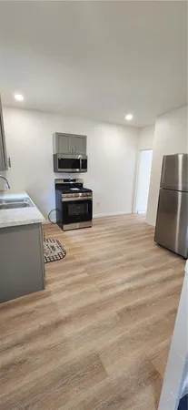 a kitchen with stainless steel appliances granite countertop a stove and a refrigerator