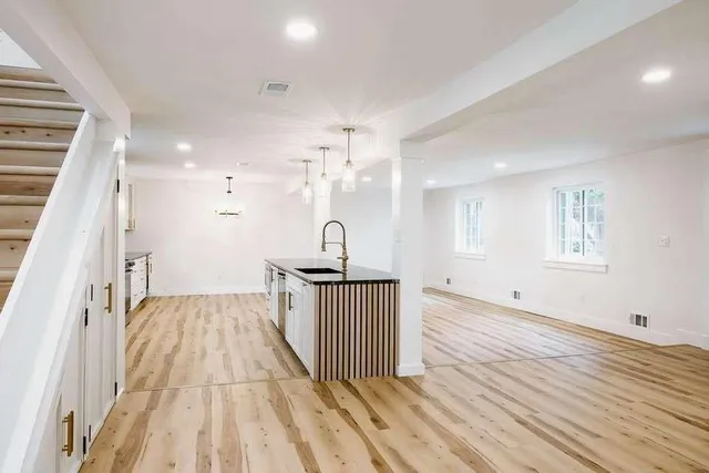a view of a room with wooden floor and window