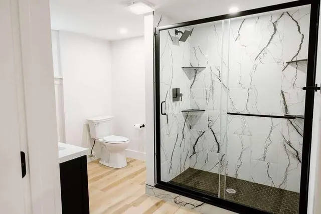 a bathroom with a shower curtain and a toilet