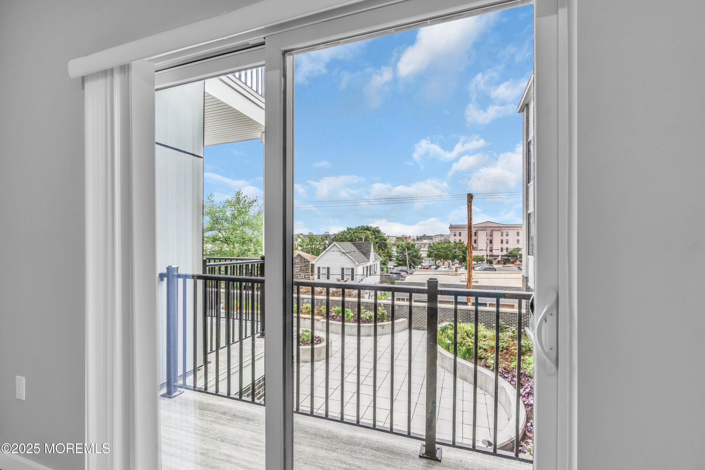 120 Monmouth Street, Unit 308 Red Bank, NJ 07701 - Photo 19 of 37 a view of a glass door and a balcony
