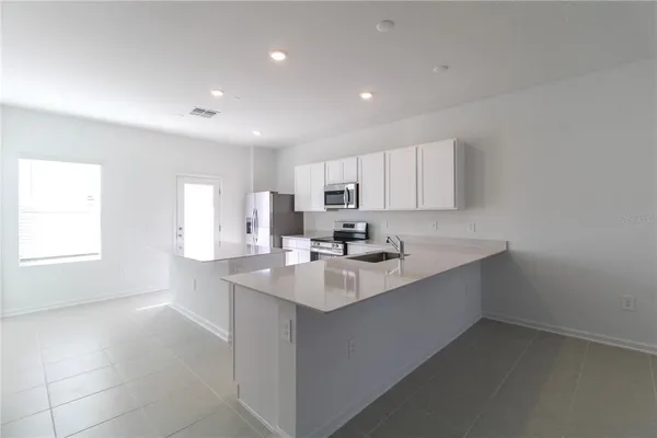 a kitchen with counter top space sink and center island