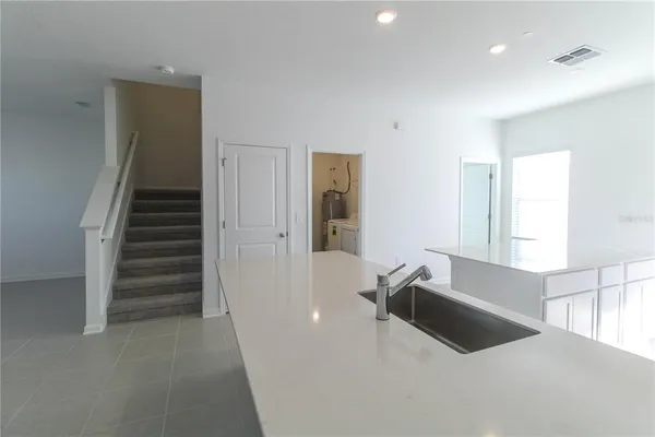 a large white kitchen with a tub