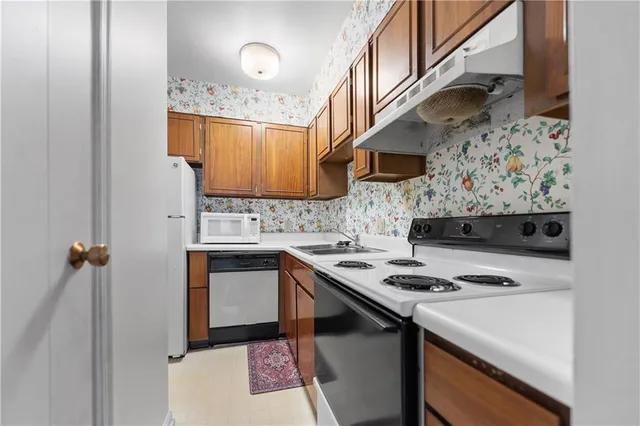 a kitchen with stainless steel appliances granite countertop a sink stove and cabinets