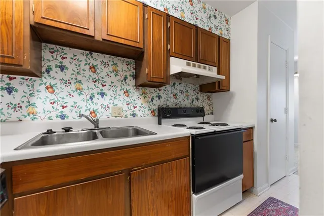 a kitchen with a sink and cabinets