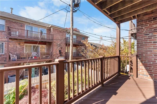 a view of a balcony with wooden floor