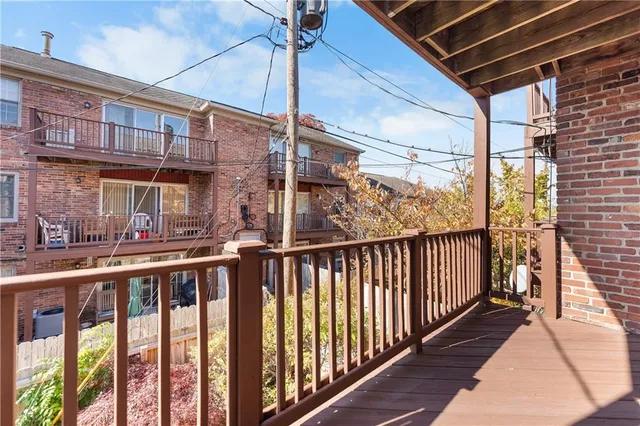 a view of a balcony with wooden floor