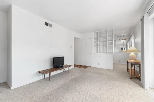 a living room with furniture and a ceiling fan