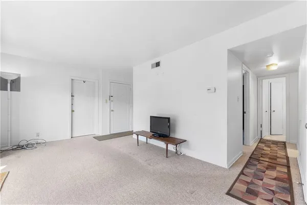 a view of hallway with wooden floor