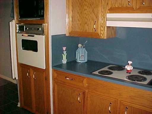 4022 Bray Drive Corpus Christi, TX 78413 - Photo 6 of 8 a kitchen with a refrigerator and a stove top oven