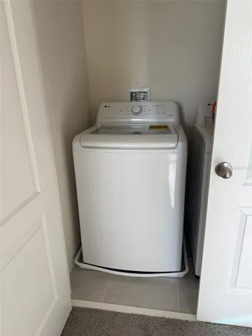 a utility room with wooden floor washer and dryer