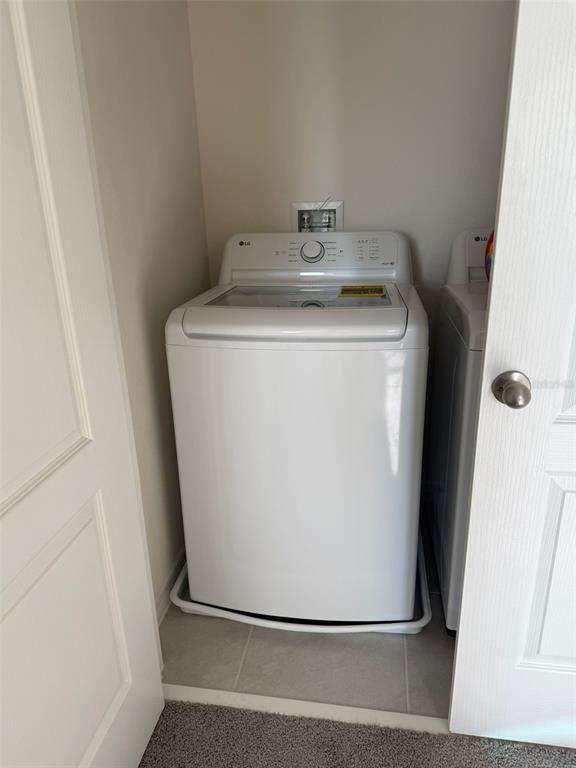 2914 Hudson Hammock Way St. Cloud, FL 34773 - Photo 19 of 30 a utility room with wooden floor washer and dryer