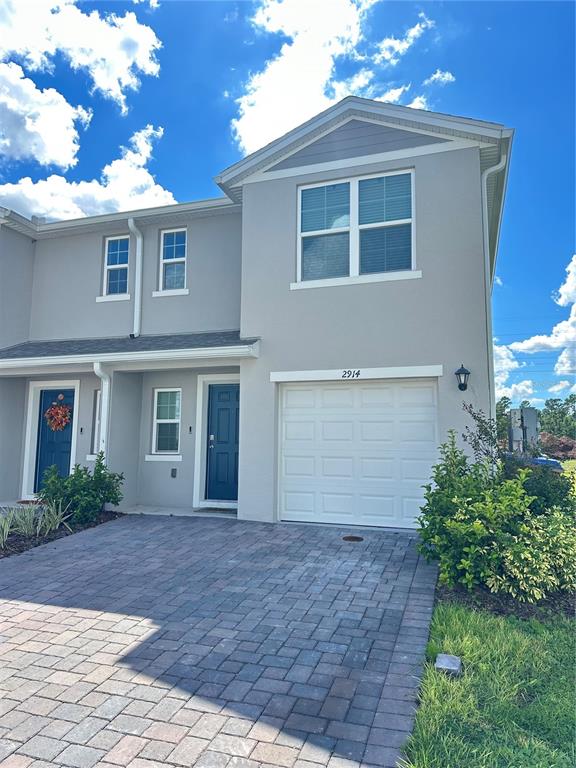 2914 Hudson Hammock Way St. Cloud, FL 34773 - Photo 2 of 30 a front view of a house with a yard and garage