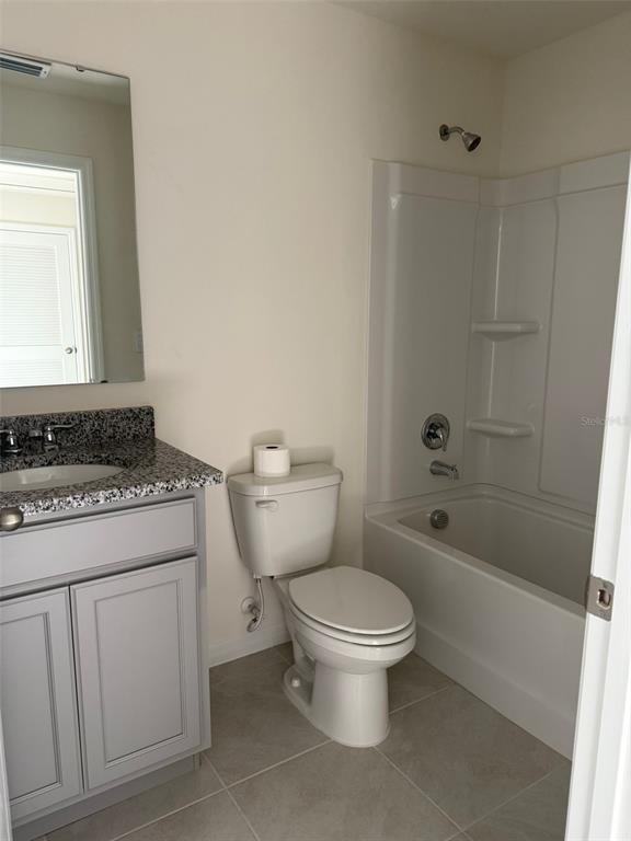 2914 Hudson Hammock Way St. Cloud, FL 34773 - Photo 25 of 30 a bathroom with a toilet sink and shower