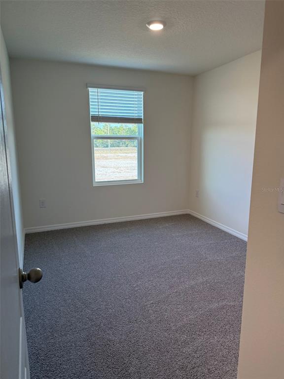 2914 Hudson Hammock Way St. Cloud, FL 34773 - Photo 27 of 30 an empty room with a window