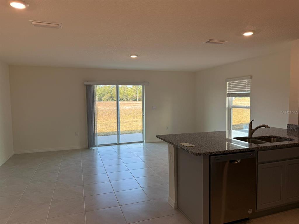 2914 Hudson Hammock Way St. Cloud, FL 34773 - Photo 29 of 30 a kitchen with granite countertop sink and cabinets
